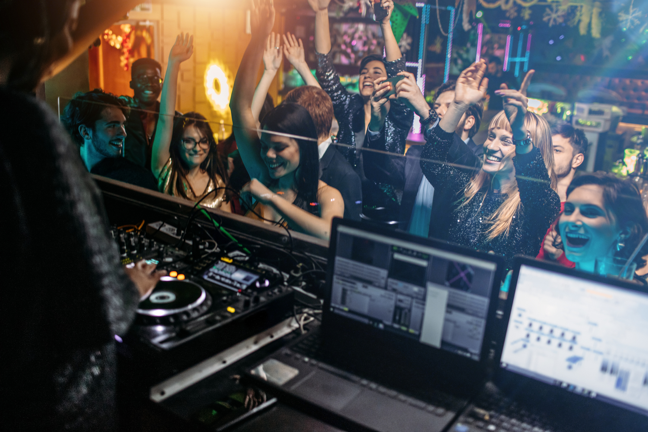 African female DJ in the nightclub entertain audience.